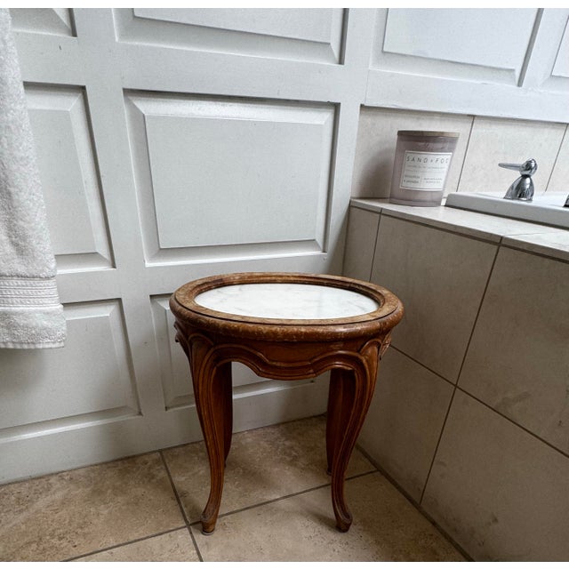 Vintage Louis XV style accent table featuring a solid oval marble inset top, carved apron, and graceful cabriole legs....