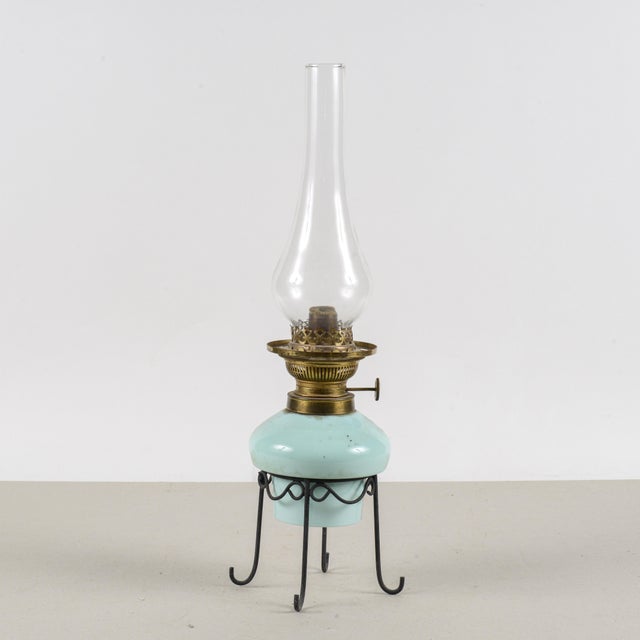 Featuring a metal base and a blue ceramic reservoir, this oil lamp is a charming piece that evokes the domestic lighting...