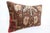 This vintage handmade lumbar pillow cover was crafted from a double knotted tribal rug, showcasing a rich composition of...