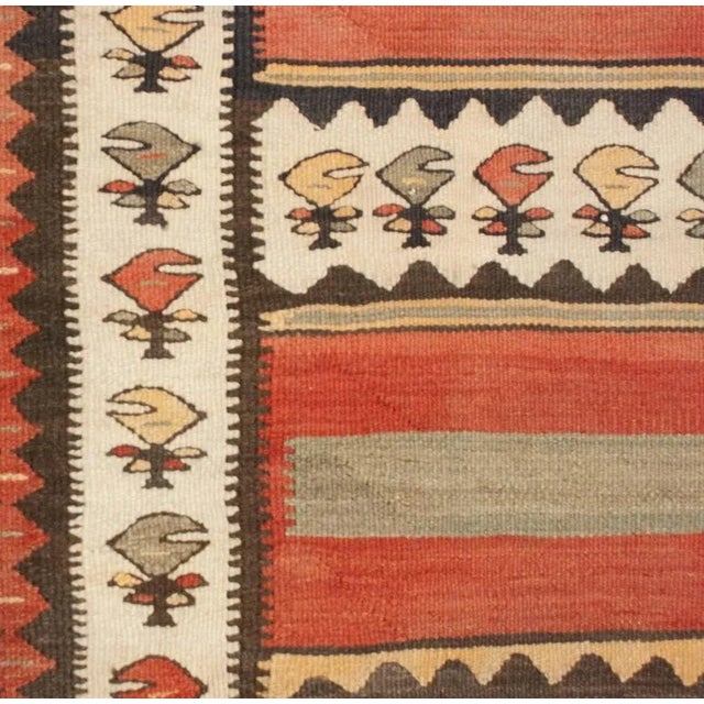 A wonderful early 20th Century Persian Zarand Kilim runner with a bold pattern of alternating crimson, pale indigo, black...