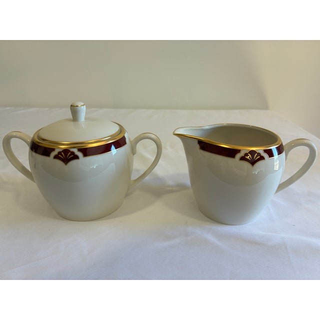 A coordinating vintage sugar bowl and creamer by Pickard in the Ensemble Burgundy pattern. Hand decorated in the USA, the...