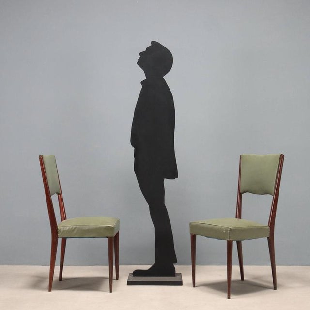 Chairs in stained beech wood, with spring and foam padding, skai covering. Decent condition. This piece is attributed to...