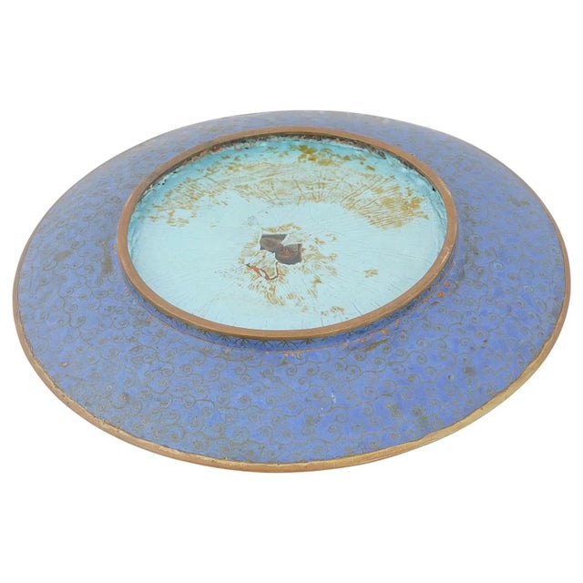 A beautifully decorated Japanese Meiji period cloisonne enamel plate depicting a pastoral scene of a young boy riding a...