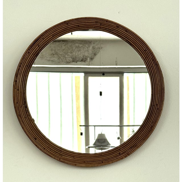 talian mid-century large, circular wall mirror made of curved rattan, 1960s. The mirror glas is the original and in very...