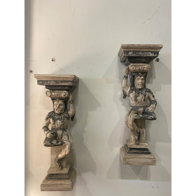 Lovely pair of primitive wood jester wall sconces with original chippy old paint. Comes ready to hang. Dimensions: 16.75 H...
