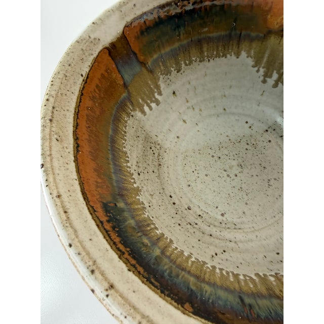 Beautiful 1980’s vintage studio pottery bowl featuring an organic hand-thrown form and rich earth-tone glazing. The piece...