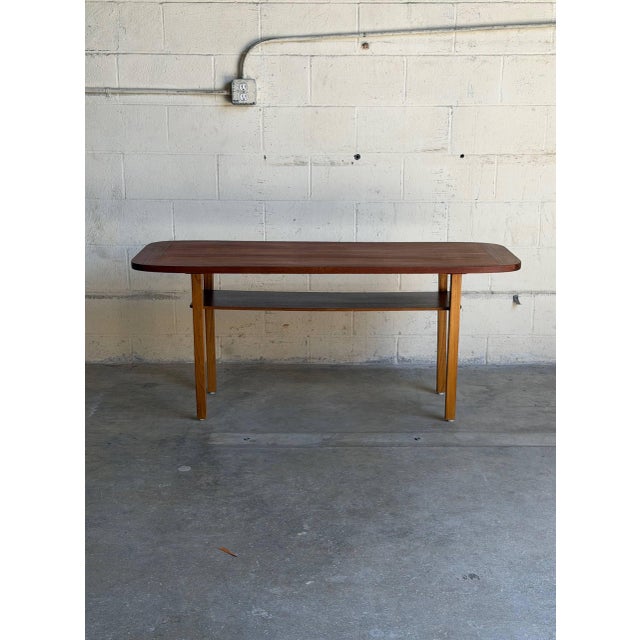 Beautiful vintage Danish Mid-Century Modern teak coffee table featuring softly rounded corners, elegant minimalist lines,...