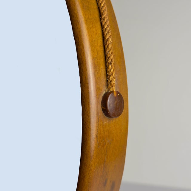 Mid-century wall mirror with Teak made in Italy in the 1960s. The vintage mirror is in very good vintage condition. The...