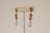 A pair of 18K gold dangle earrings with detailed granulation and wire work with a faceted, round aquamarine drop at the...