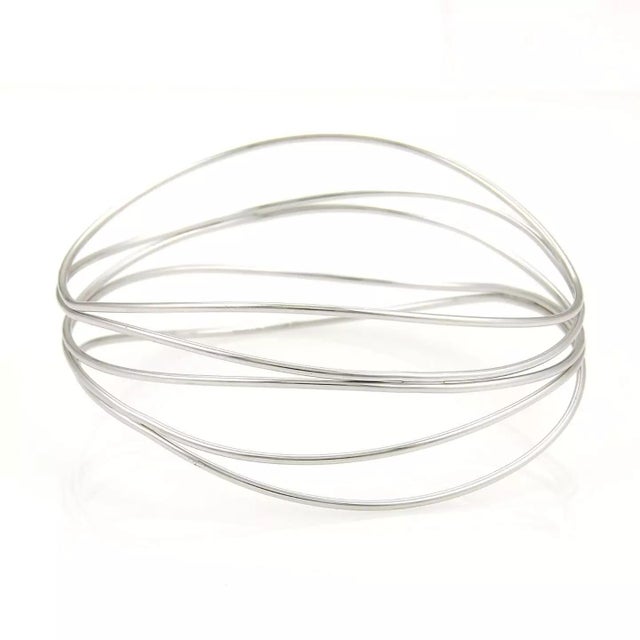 This beautiful authentic wire bangle bracelet is from Tiffany & Co. by designer Elsa Peretti from her Wave collection, it...