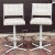 Pair of swivel barstools by Douglas Furniture with white upholstered seats and backs on white enameled steel tubular bases...