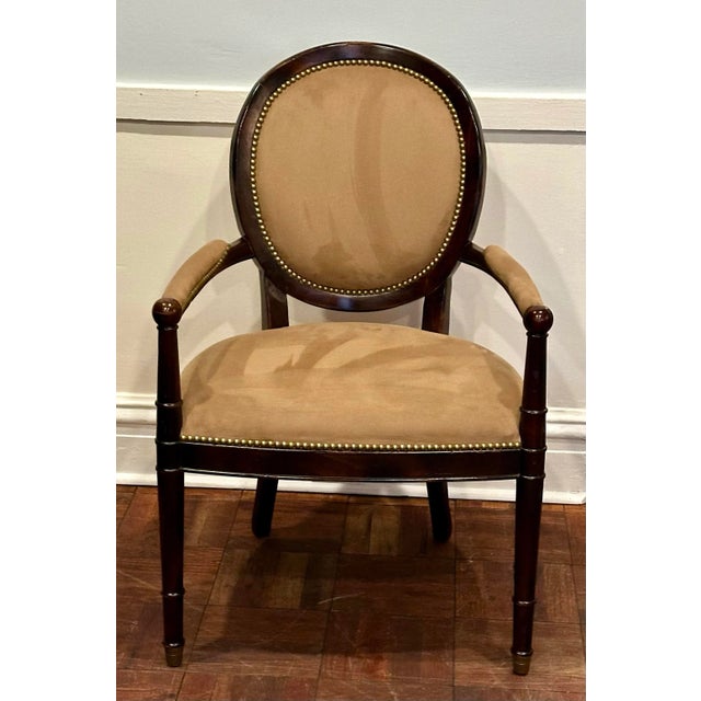 A classic Louis XVI–style bergere armchair by Milling Road for Baker Furniture, offering timeless French form with Baker’s...