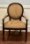 A classic Louis XVI–style bergere armchair by Milling Road for Baker Furniture, offering timeless French form with Baker’s...