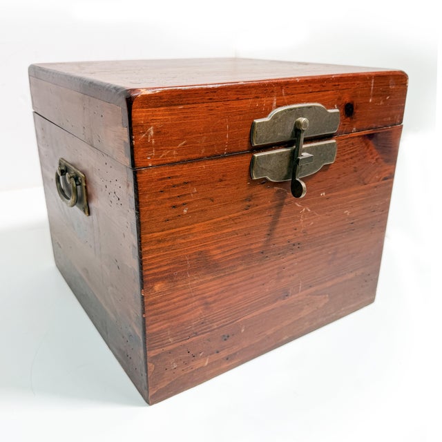 This antique handmade wooden storage chest with substantial solid-wood construction, traditional dovetailed corner joinery...