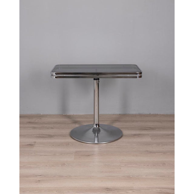 Side table with chromed metal frame and smoked glass top, designed by Arredamenti Allegri Parma, 1970s. This piece has an...