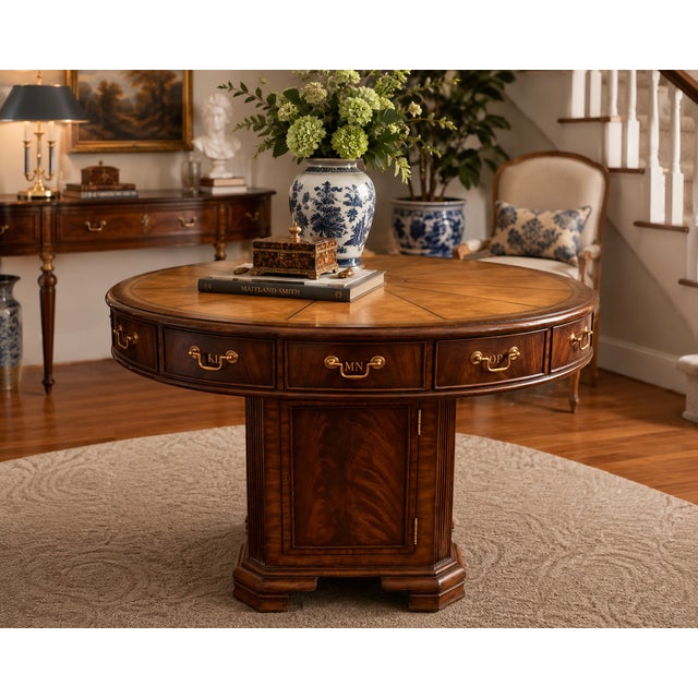 An exceptional vintage Maitland-Smith rotating rent table, masterfully crafted with rich flame mahogany, burlwood inlay,...