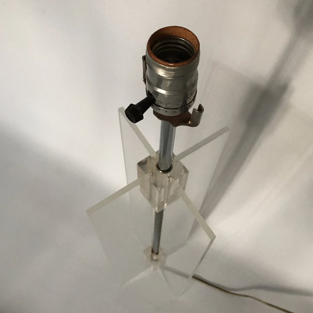 A single rectangular X shape clear lucite and chrome table lamp. 23.5" to top of socket.