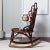 An exquisite survivor of 19th-century American craftsmanship, this sculptural wicker and cane rocking chair embodies the...