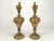 A stunning pair of decorative brass ewers, rich with the opulent detailing of Rococo Revival design. These mid-century...