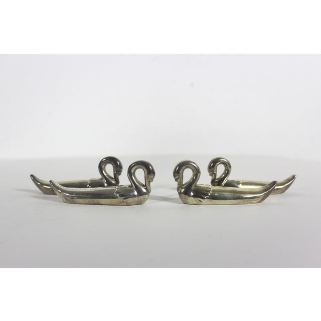 Charming set of four silver plated swan knife or chopstick rests. Some tarnish and possible small spots of corrosion