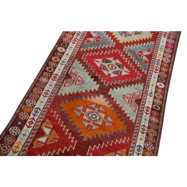 Introducing a one-of-a-kind vintage Turkish hand-knotted wool rug, carefully crafted by skilled artisans using traditional...