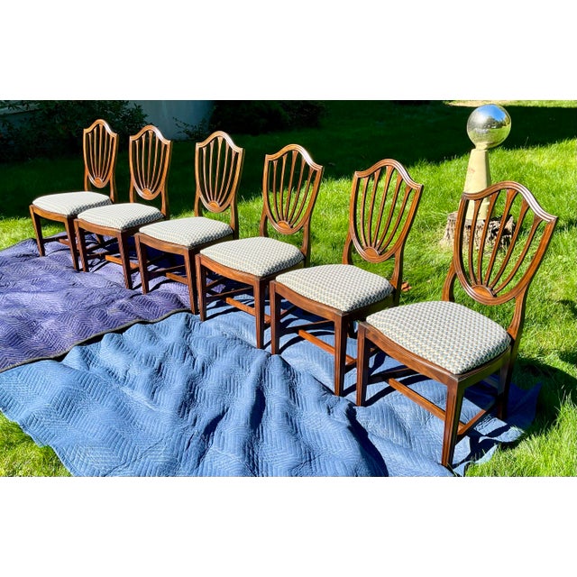 Elevate your dining space with this exceptional, transitional set of six (6) vintage shield-back dining side chairs....