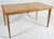This is a vintage Heywood Wakefield maple dining table, often found in a "champagne" or "wheat" finish.