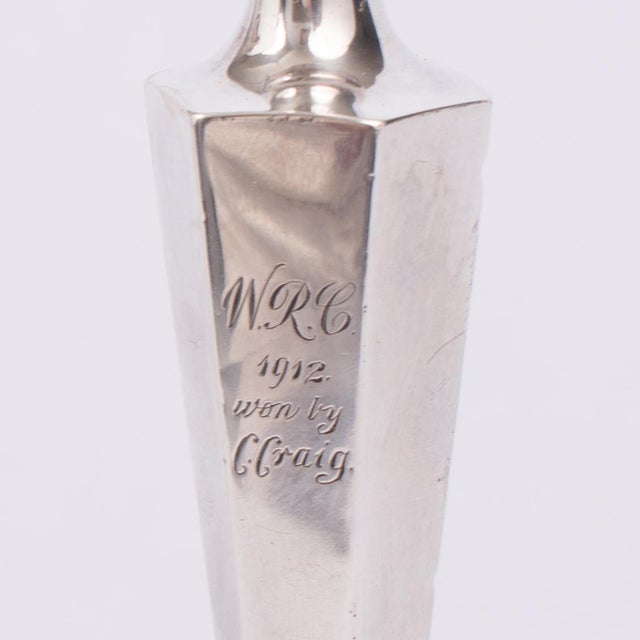 A handsome and evocative pair of Edwardian sterling silver presentation candlesticks, originally awarded as rowing...