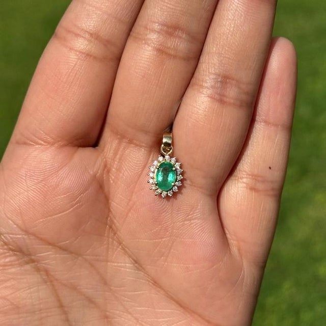 This dainty pendant showcases a 0.65 carat of natural emerald set in 14K yellow gold. The emerald measuring 6.8 x 4.7 mm,...