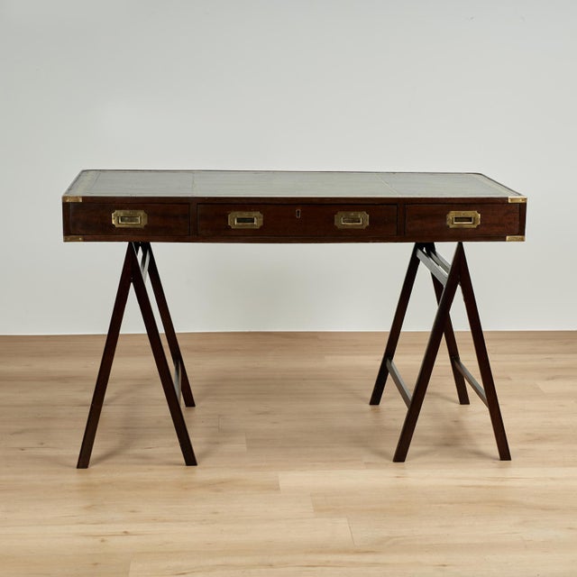 Handsome 19th century British colonial desk handcrafted in mahogany, having the original tooled and gilt green leather top...