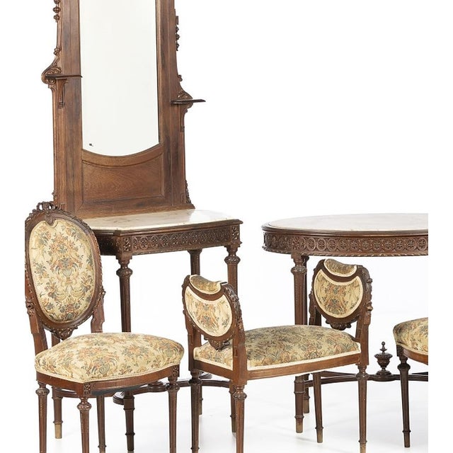 Living room furniture. Portuguese; early 20th century, made of walnut wood. Comprising: a side table; coffee table; three...
