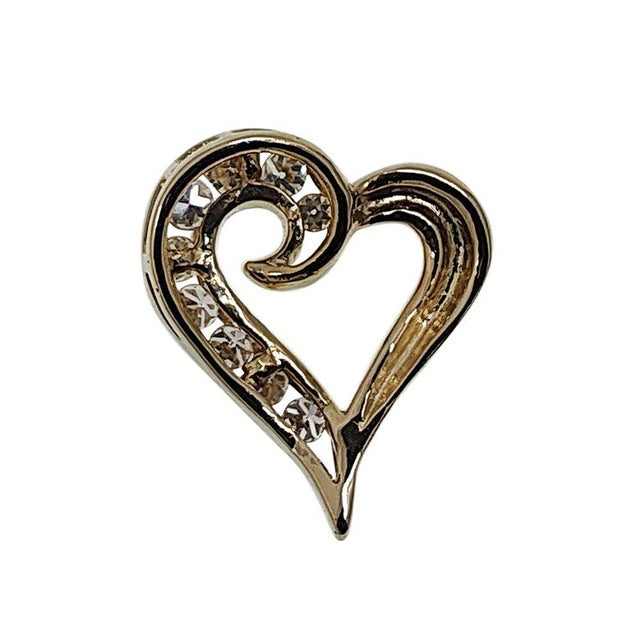 Estate 14K gold diamond heart pendant. This estate heart pendant is crafted in 14 karat yellow gold featuring single cut...