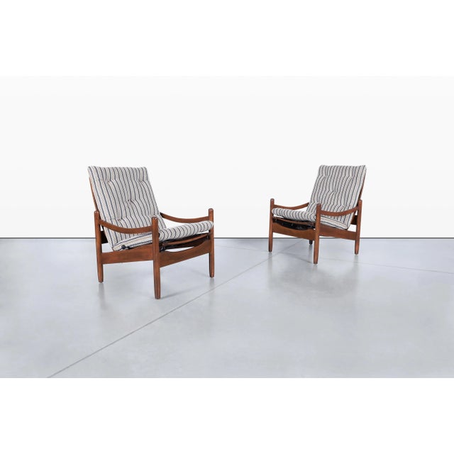 Pair of mid-century modern reclining high-back lounge chairs crafted in the United States during the 1960s, blending...