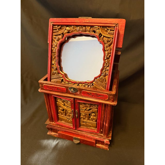 Charming mid-20th century Chinoiserie jewelry cabinet or vanity box, hand-crafted in richly stained red wood with...