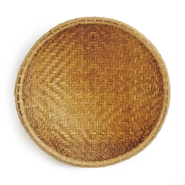 Vintage Javanese bamboo hand woven round basket with attractive two-tone natural fibers. Many uses from storage to...