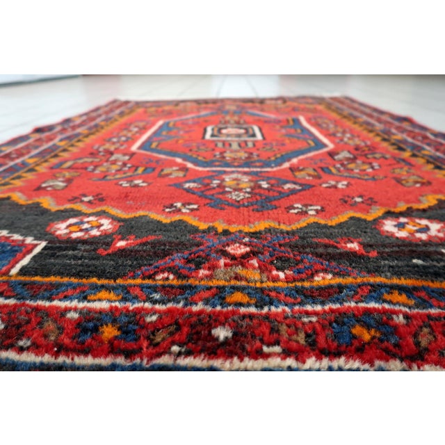 A vibrant handmade vintage Persian Hamadan rug from the 1930s, featuring a bold and lively geometric design centered...