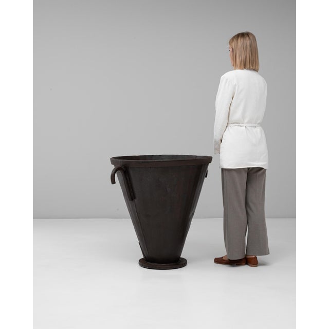 This 20th Century French wrought iron flared urn exemplifies rustic industrial craftsmanship with its bold, sculptural...