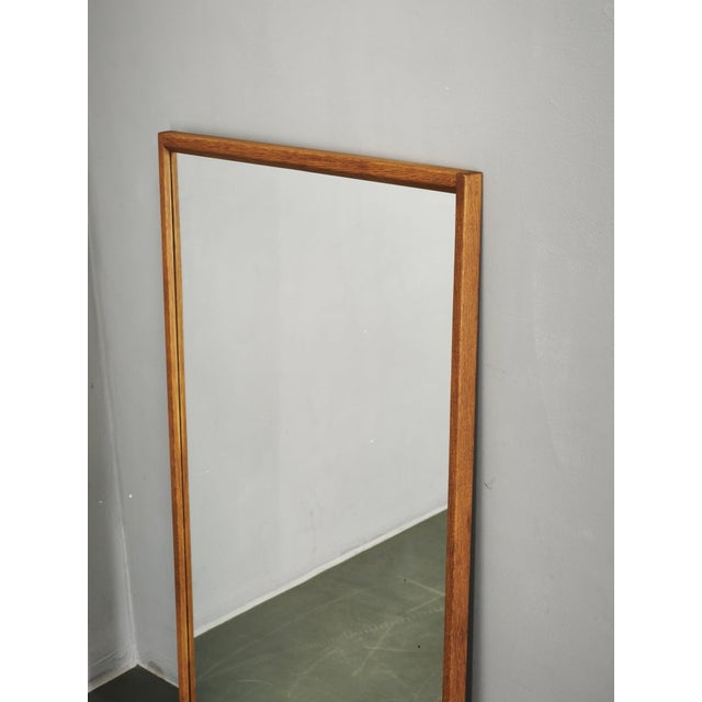 An elegant Danish Modern rectangular oak wall mirror, Model No. 146, by Aksel Kjersgaard of Odder, Denmark. Characterized...