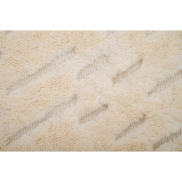 Refined hand-knotted wool rug in Ivory, showcasing a dynamic diagonal dash pattern. The interplay of raised textures adds...