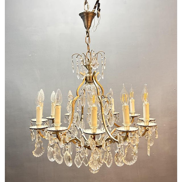 Elegant vintage crystal chandelier dating from the 1960s, featuring a beautifully balanced classical design with a nickel-...