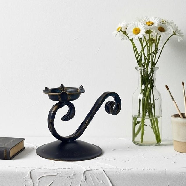 Visual Poetry in Metal: Experience the Rhythm of the Cadence Candlestick. Infuse your home with a sense of graceful...