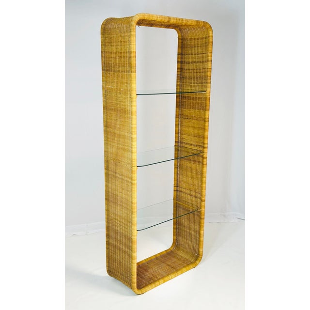 An exceptional American Mid-Century Modern wicker and glass étagère designed and manufactured by Founders in the United...
