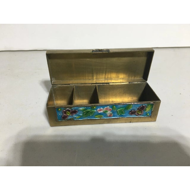 This solid brass box has enamel panels on the top, left & right sides and front side There is a stamp of CHINA on the...