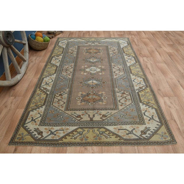 Vintage Turkish Hand-Knotted vintage rug is a semi- vintage area rug.'70s Eastern region of Turkey's unique rug is...
