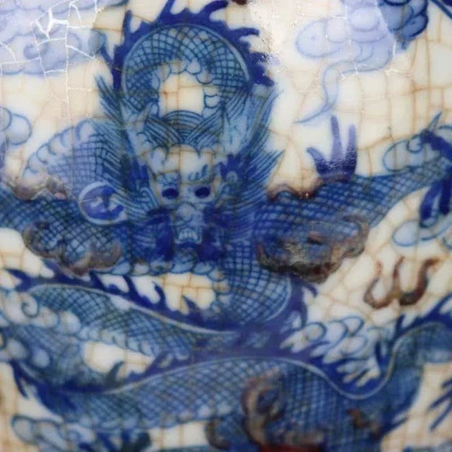 W-16.5cm,H-20.4cm The Kangxi Marked Blue and White Underglaze Red Porcelain Jar with a painted Cloud Dragon is a stunning...