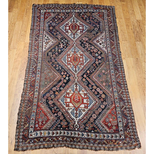 "Discover the captivating artistry and rich history of this beautiful Late 19th Century Qashqai tribal area rug from South...