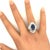 A striking cocktail ring featuring a 5.82-carat oval-cut blue sapphire. The sapphire's deep blue hue is complemented by...