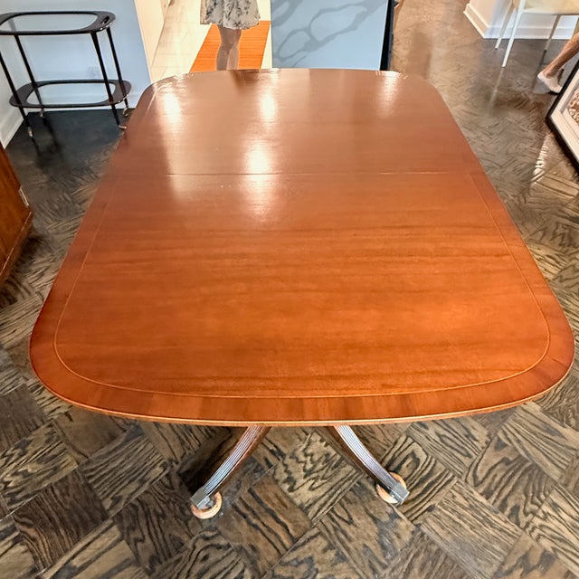 Baker Georgian Style Double Pedestal Mahogany Dining Table A gorgeous banded mahogany dining table from Baker Furniture....