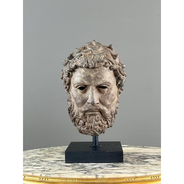 A superb bronze sculptural bust depicting a bearded male head in the Greco-Roman style, evoking the great figures of...