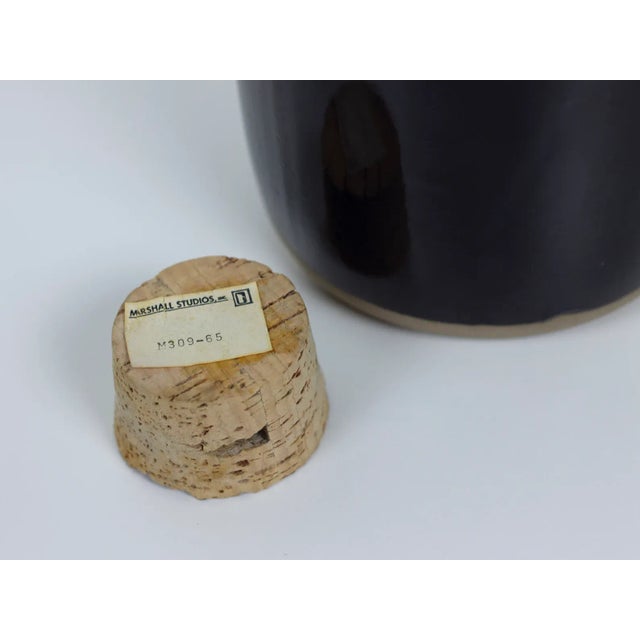 Vintage stoneware ceramic pitcher model M309-65 with black glaze and a cork stopper by Jane and Gordon Martz for Marshall...